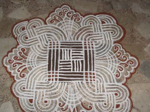 Kolam rangoli alpana design with lines and flowers