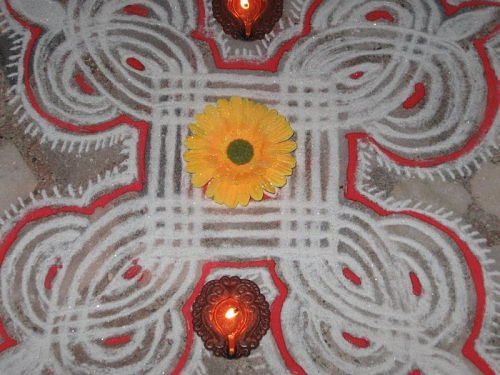 Diwali rangoli using moist chalk and kumkum